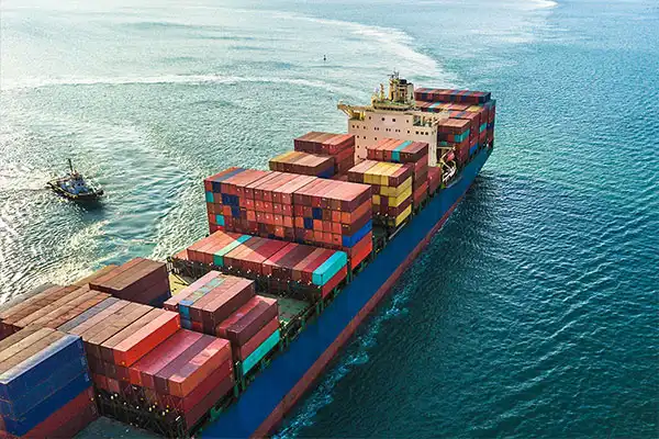 cargo ship filled with containers moving on the sea