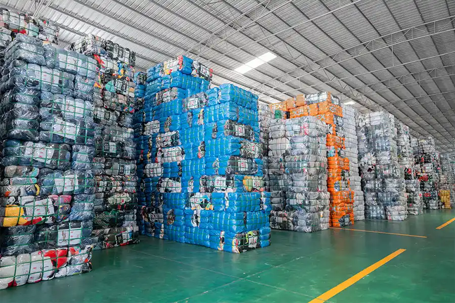 bales of used clothing stacked and ready for order fulfillment