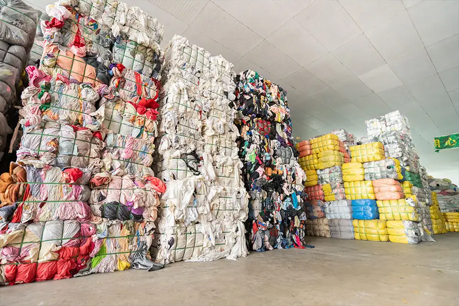 tall stacks of expertly packed used clothing