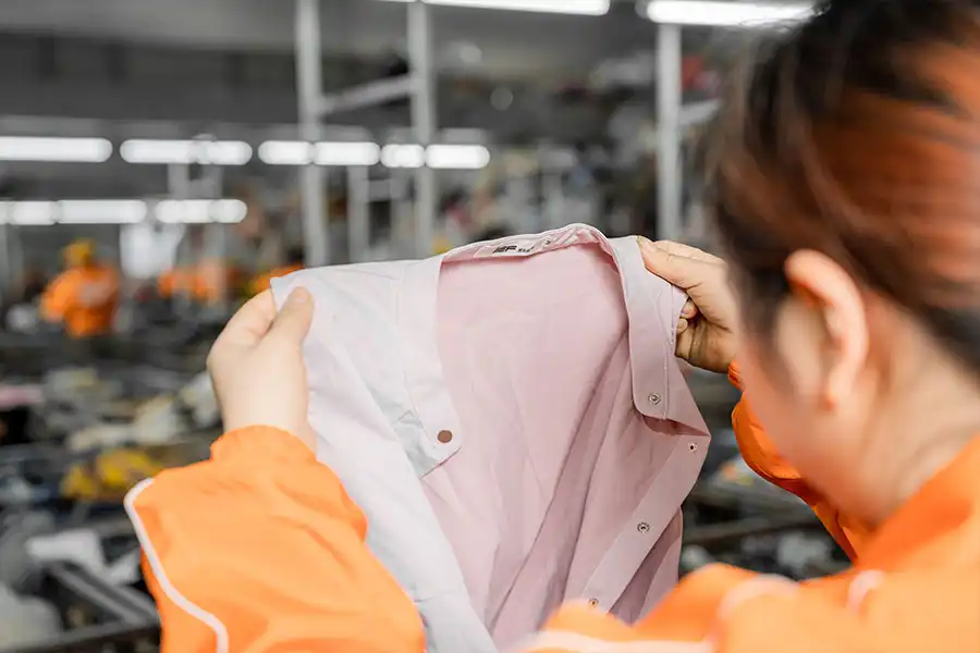 sorter checking the collar of a used clothing