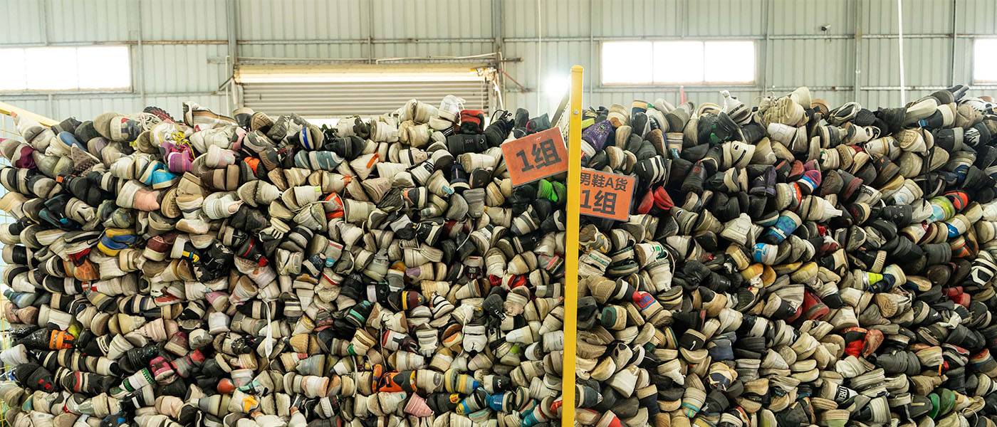 stacks of used shoes piled on the warehouse