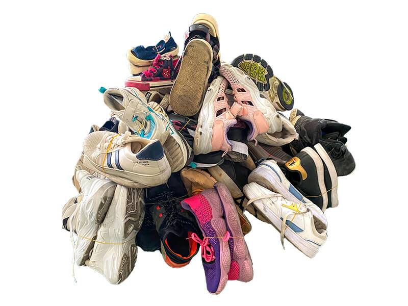 pile of used shoes ready for sorting and inspection