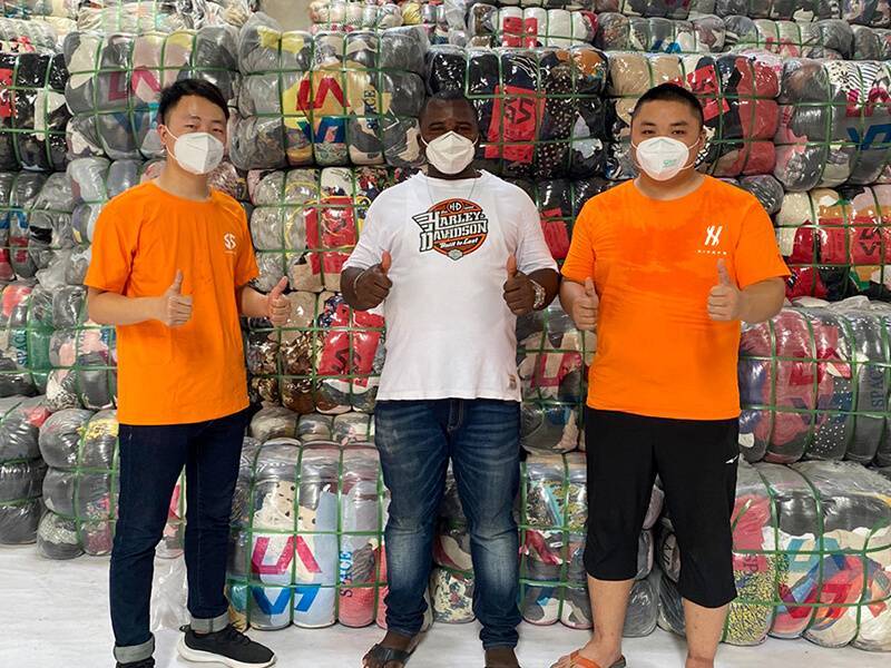 two HissenGlobal staff taking a picture with a visiting customer