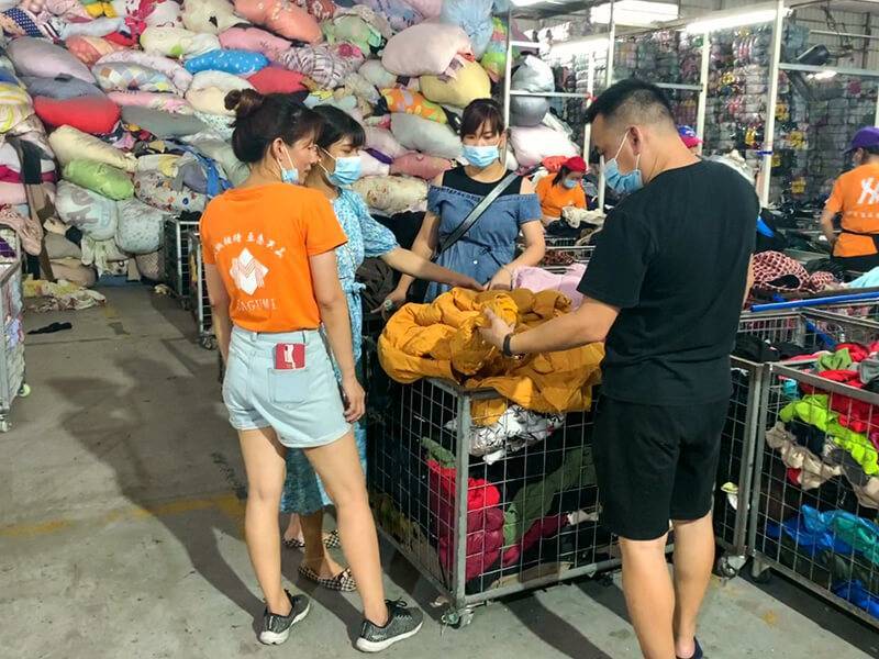 customers looking at the quality of our meticulously-sorted used clothing